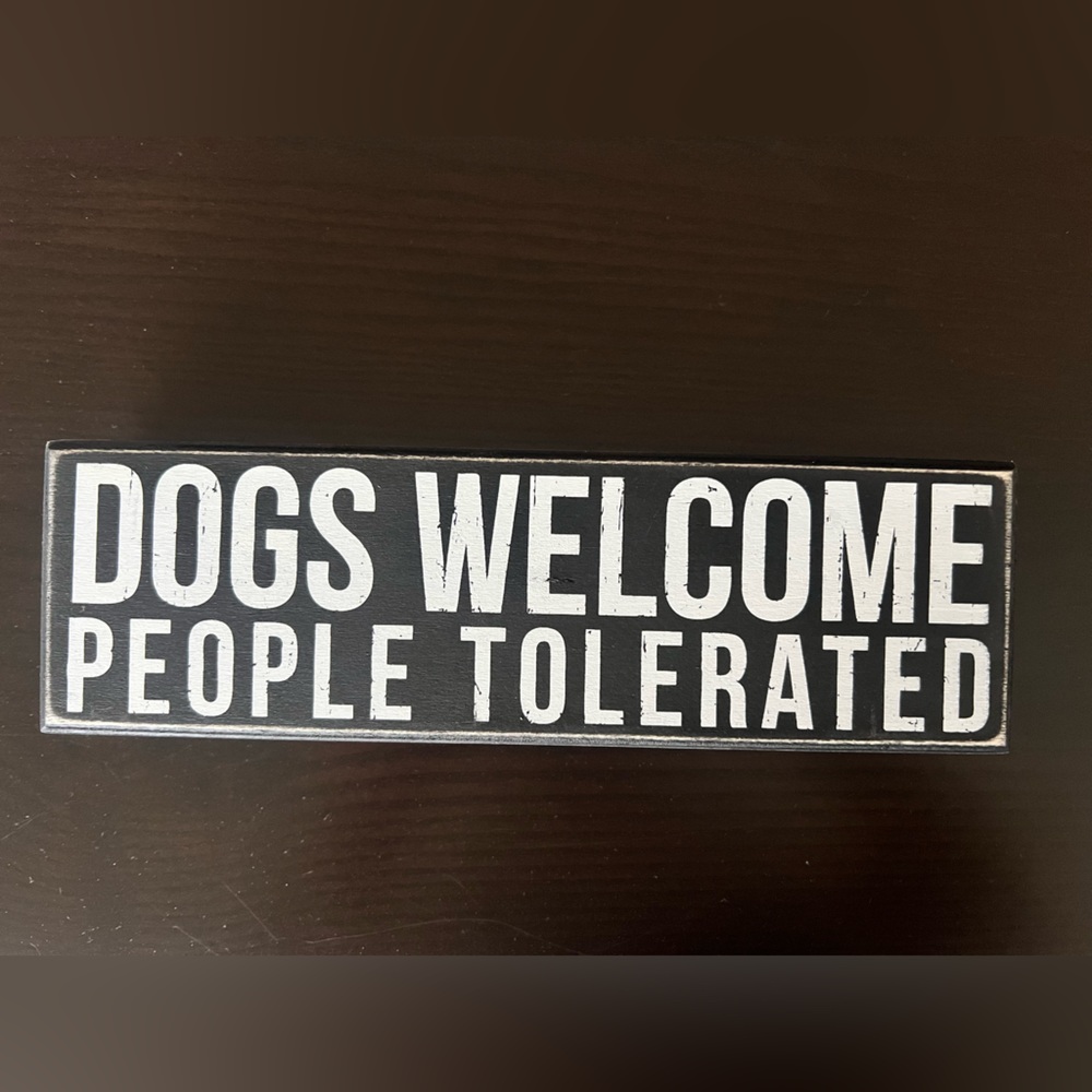 Dogs welcome people tolerated sign.
